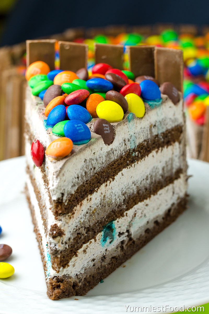 KIT KAT and M&M Chocolate Cake With Peanut Butter Frosting - served on the plate