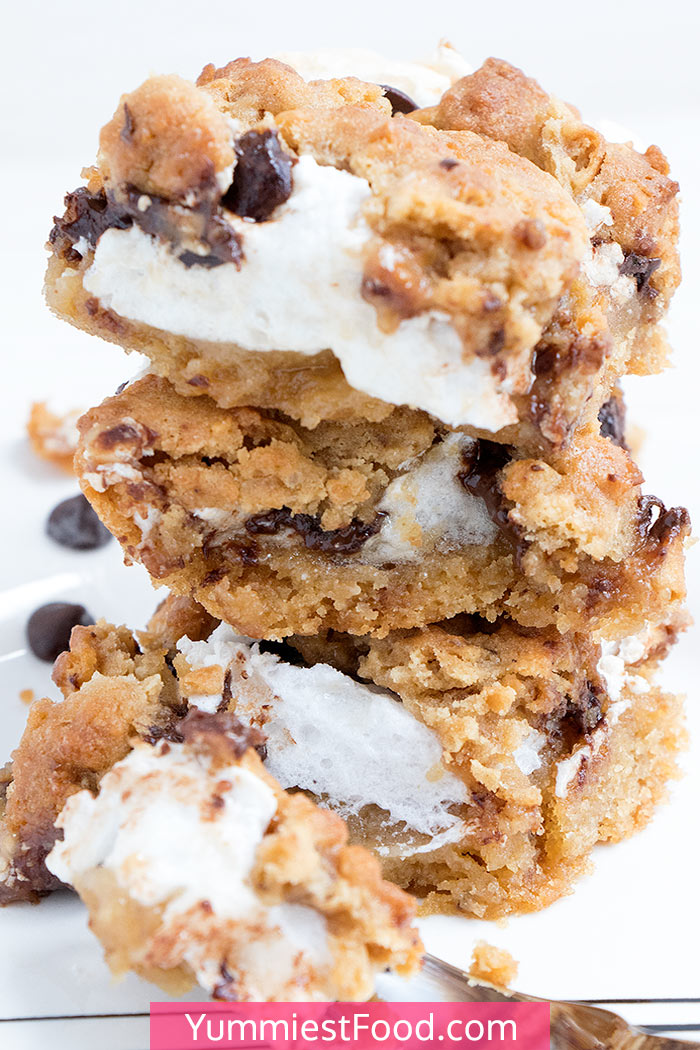 S’Mores Chocolate Chip Cookie Bars are one of the sweet treats perfect for a crowd or parties! Easy delicious dessert with graham crackers, chocolate chips and homemade marshmallow cream. #desserts #dessert #dessertrecipes #dessertfoodrecipes #easyrecipes #potluck #chocolate #chocolatechip #bars #barsrecipes #cookiebars